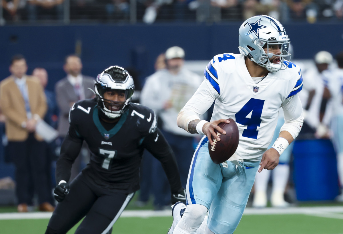 Prescott is pursued by Philadelphia Eagles edge rusher Haason Reddick. 